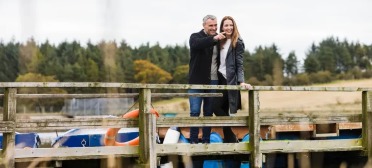 Man and Woman couple exploring the surrounding area of Stewart's Resort in Scotland.