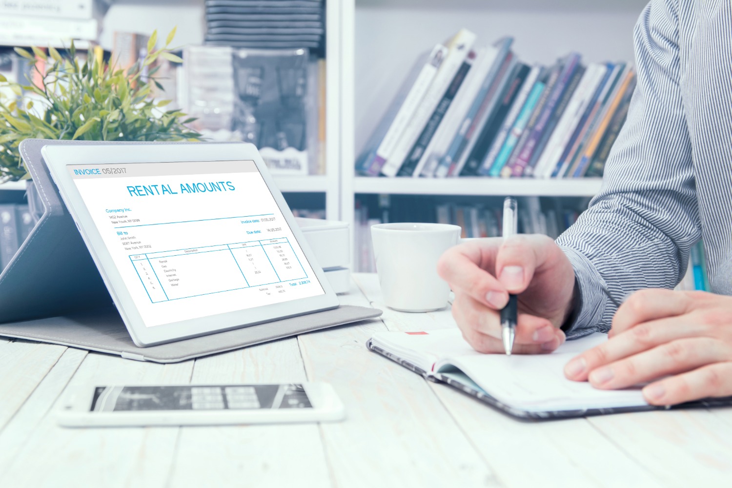 Person reviewing rental invoice on tablet